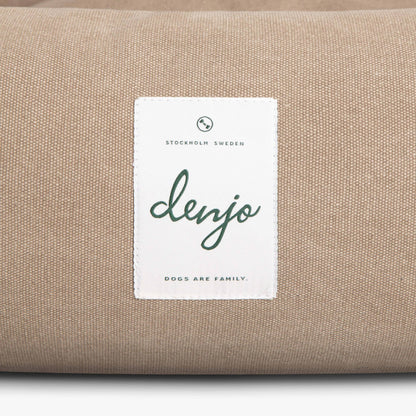 Beige fabric with a 'denjo' label on a white background