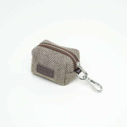 Small herringbone-patterned pouch with a zipper and keychain clip on a white background