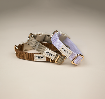 Two dog collars with 'Drew' branding on a beige background