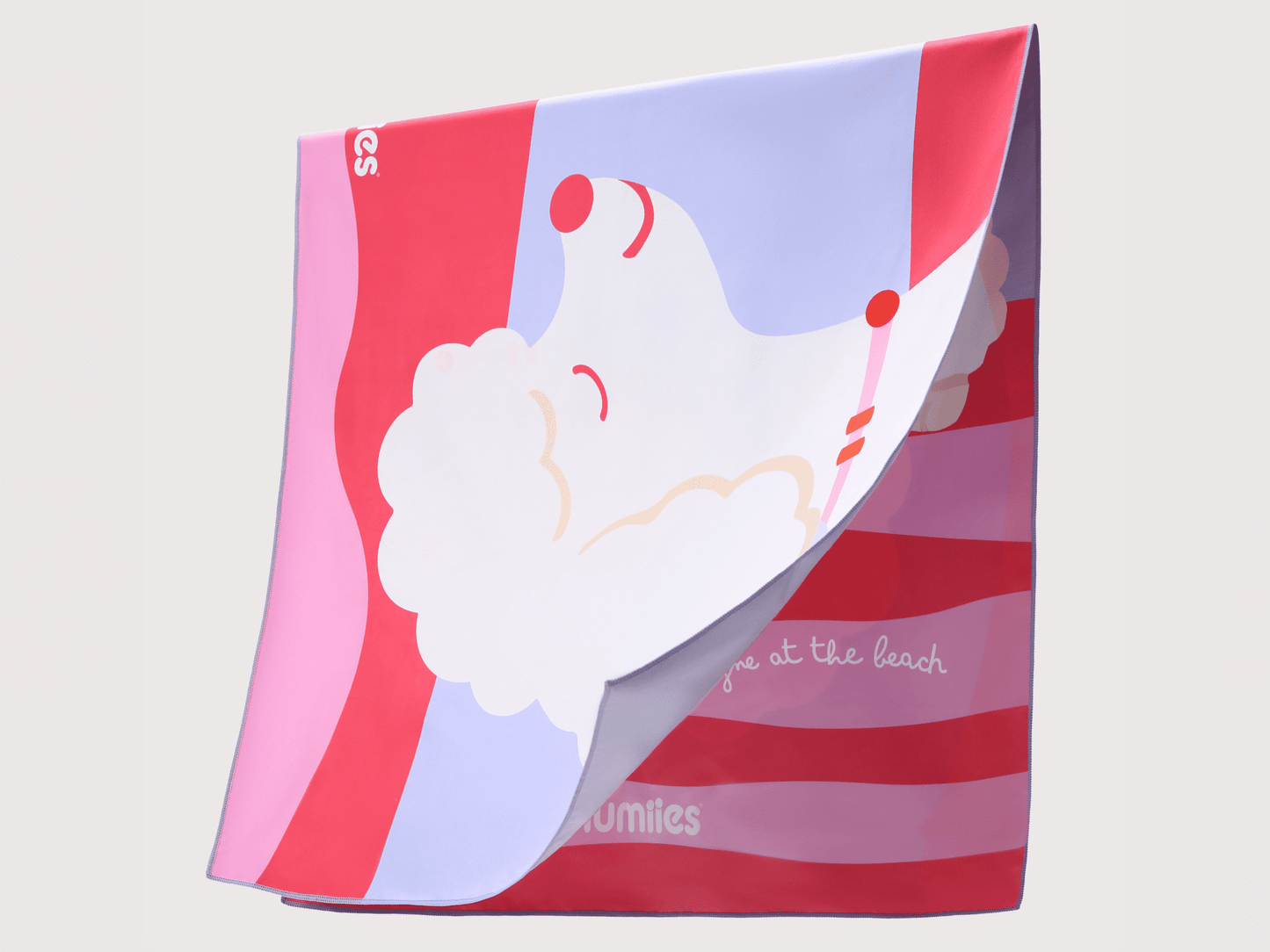 Colorful towel with a cartoon design of a beach scene on a light gray background