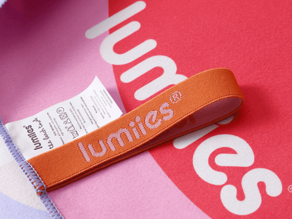 Orange band with 'lumities' branding on a pink background