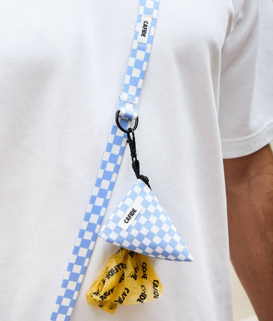 Person wearing a white shirt with a blue checkered lanyard and triangle-shaped product.