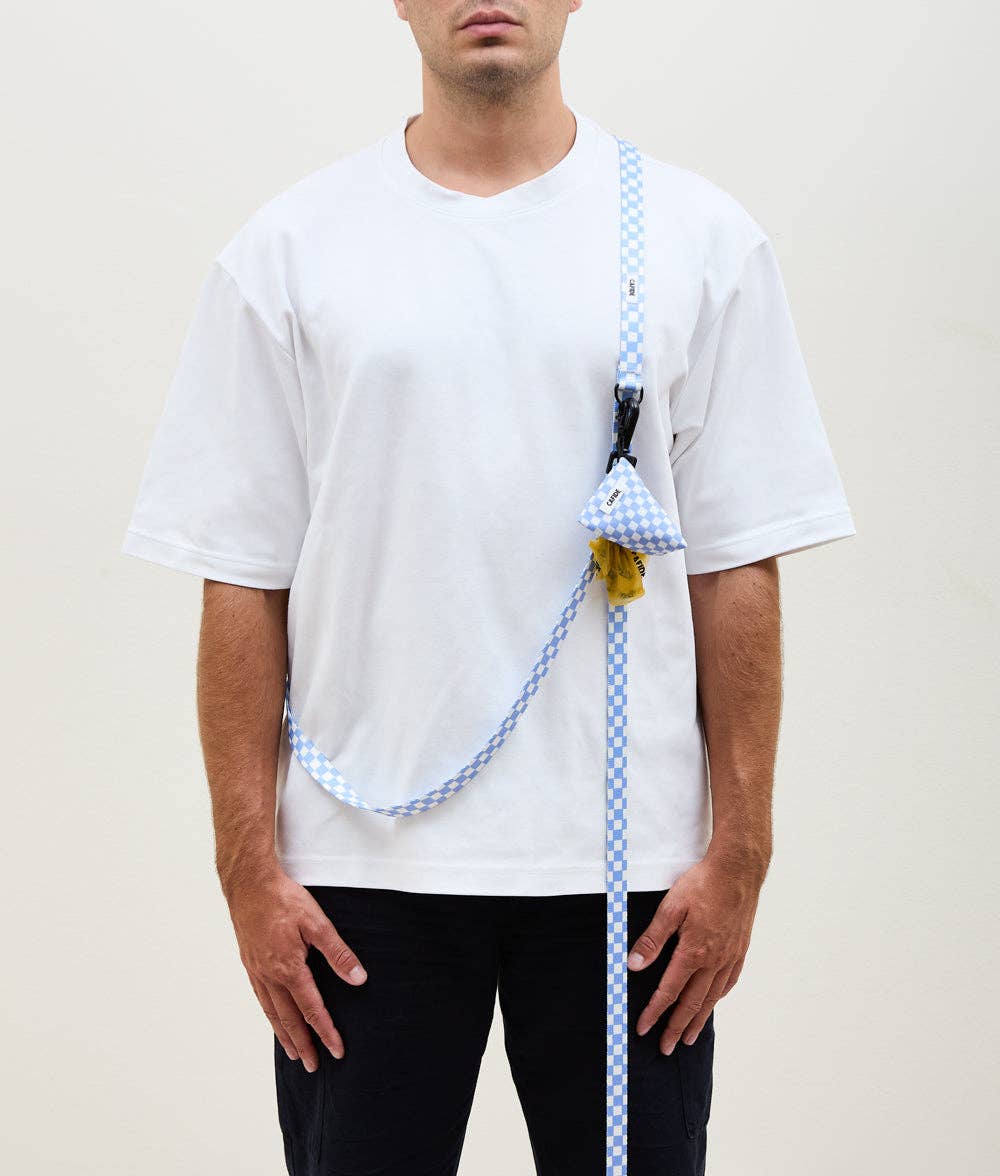 Person wearing a white shirt with a blue checkered lanyard and triangle-shaped product.