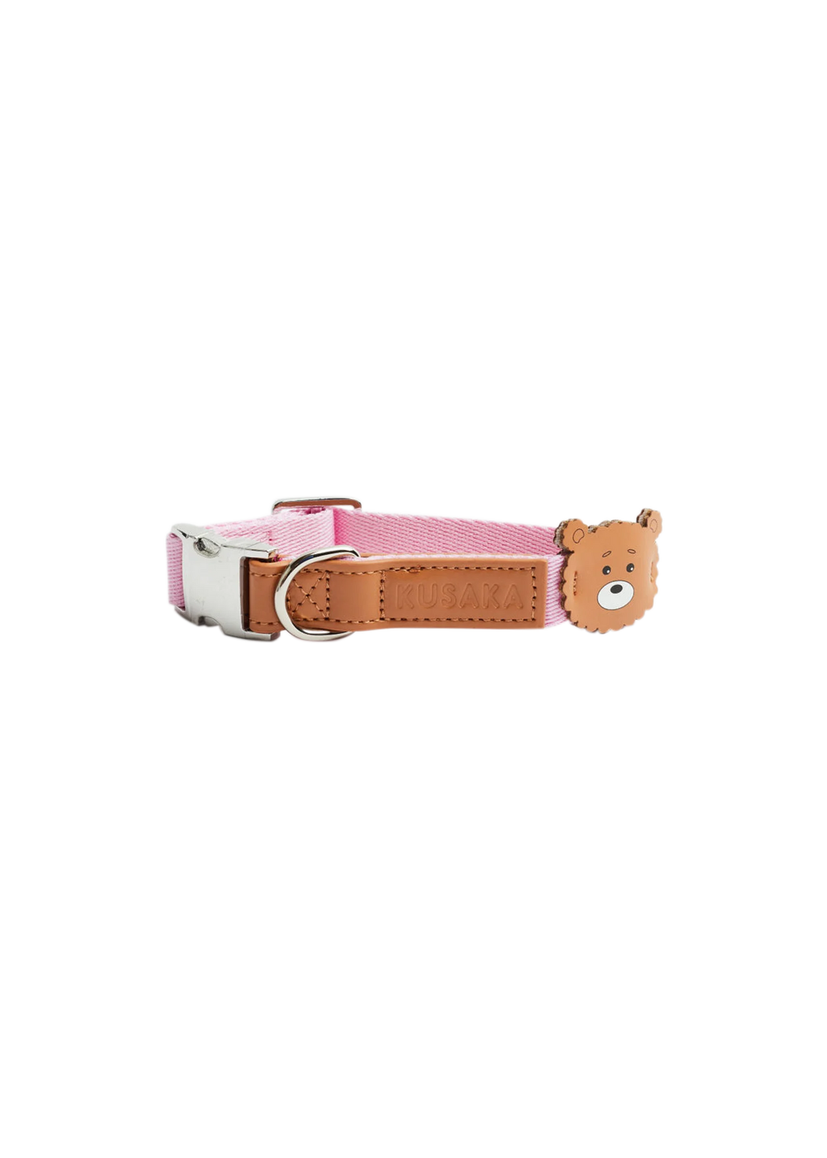 A pink fabric dog collar with a tan leather strap, silver buckle, and a small 3D bear head charm on the side.
