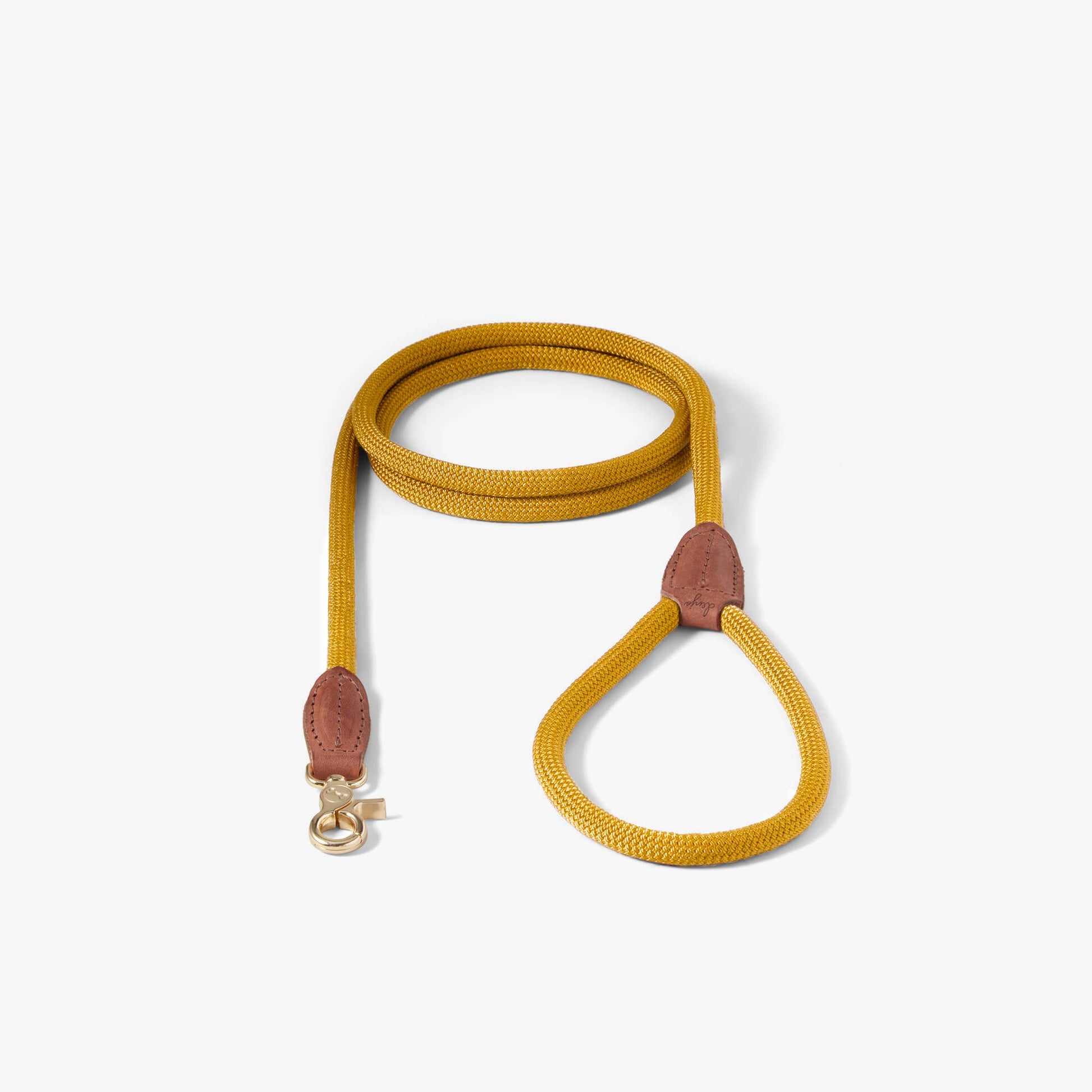 Yellow dog leash with brown leather ends on a white background