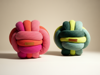 Two colorful knot toys on a neutral background