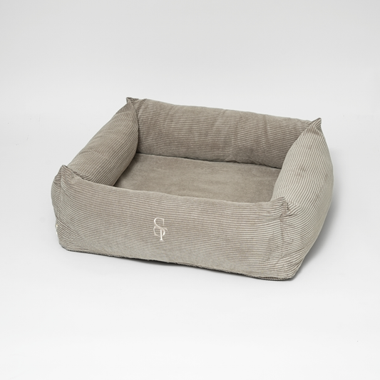 Gray pet bed with a logo on a white background